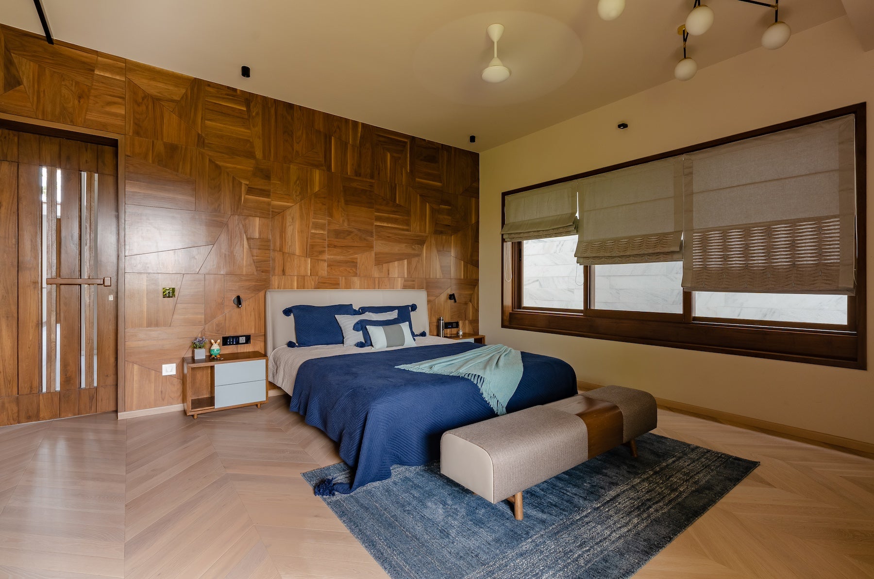 elegant and spacious master bedroom with custom wooden furniture, stylish ottoman bench and side table. Perfect inspiration for bedroom decor