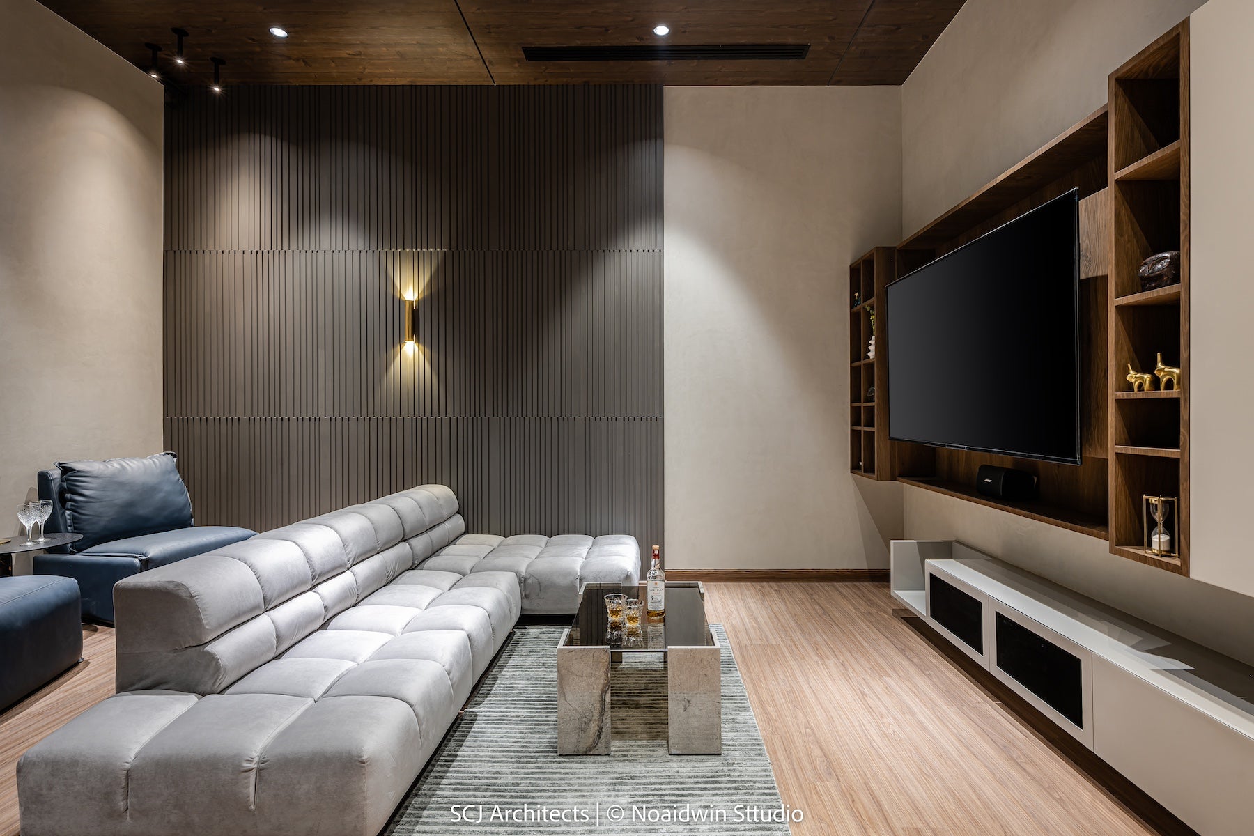 Luxury home theater furniture featuring a silver lounge sofa, two designer accent chairs, a marble center table with a glass top, and a matching side table—crafted for a stylish and comfortable cinematic experience.